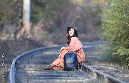 Autumn portrait of Fashion model on railway rails