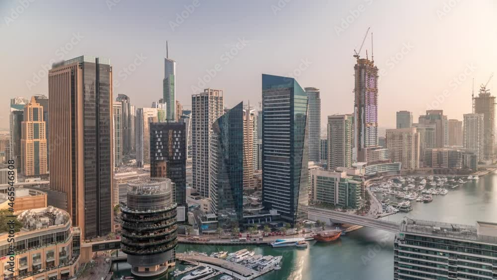 Aerial view to Dubai marina skyscrapers around canal with floating boats timelapse Aerial view to Dubai marina skyscrapers around canal with floating boats timelapse