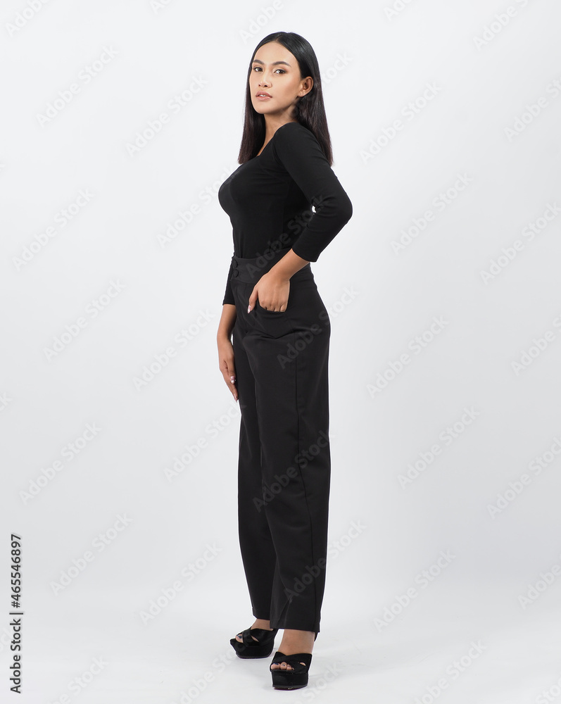 Asian woman full body. Thai woman in a modern chic style stands in white studio with elegant and confident pose. Casting model supporting actor actress. Asian woman fullbody pose in front of camera. Asian woman full body. Thai woman in a modern chic style stands in white studio with elegant and confident pose. Casting model supporting actor actress. Asian woman fullbody pose in front of camera.