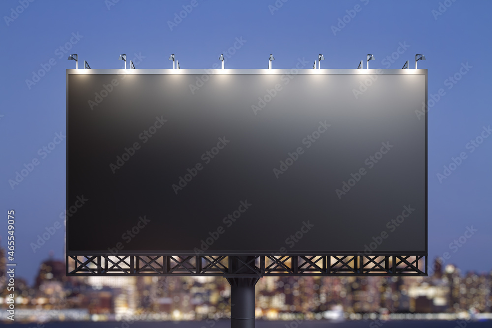 Blank black billboard on city buildings background at night, front view. Mockup, advertising concept Blank black billboard on city buildings background at night, front view. Mockup, advertising concept