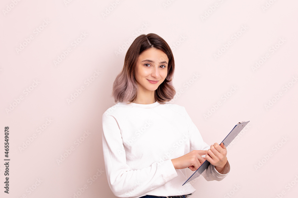 Portrait of a young girl model beautiful and natural with a tablet in her hands in the studio Portrait of a young girl model beautiful and natural with a tablet in her hands in the studio