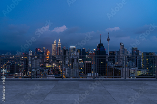 Panoramic Kuala Lumpur skyline view  concrete observatory deck on rooftop  night. Asian corporate and residential lifestyle. Financial city downtown  real estate. Product display mockup empty roof