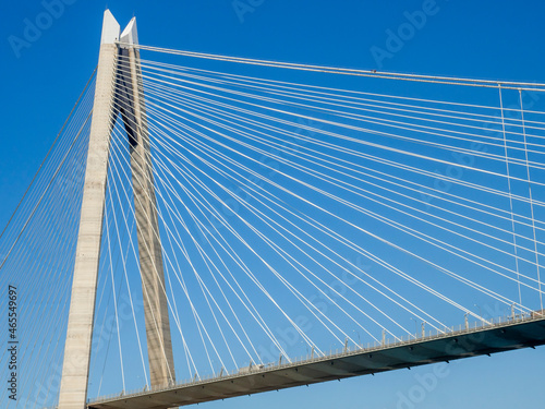Close up suspension bridge structure part of Yavuz Sultan Selim bridge in Istanbul connecting Asia and European continents. Clean blue sky background © woodpencil