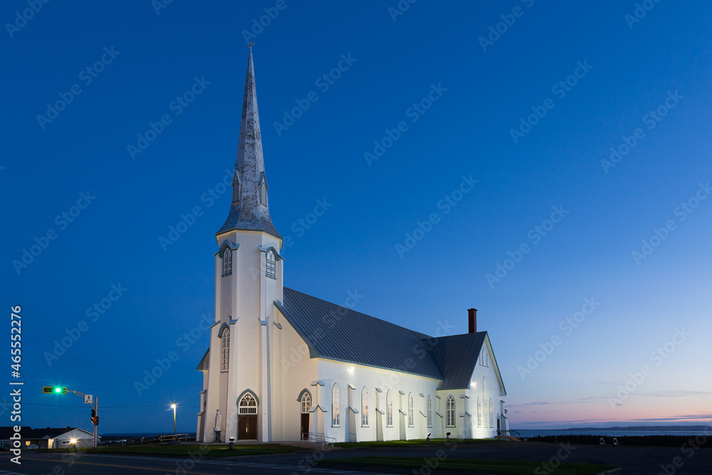 Blue hour sunset view of historic 1881 St. Pierre-de-la-Verniere Church in Cap-aux-Meules, Magdalen Islands, Quebec, Canada