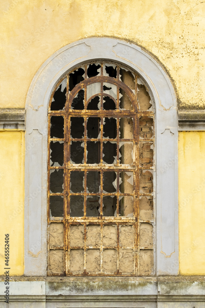 Fototapeta premium beautiful decrepit painted window of an old and abandoned house in the old town of Faro, Algarve, Portugal