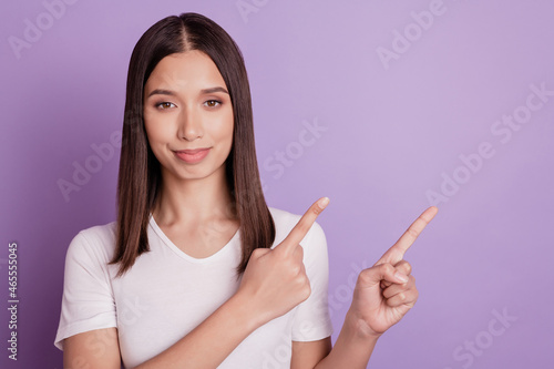 Photo of young girl happy positive smile indicate finger empty space direct way follow advert isolated on violet color background