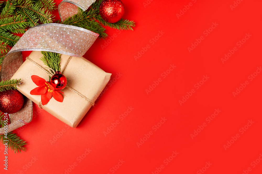 Christmas background with paper gift box, fir tree and decorations on red. Preparation for holidays. Top view with copy space. Christmas background with paper gift box, fir tree and decorations on red. Preparation for holidays. Top view with copy space.
