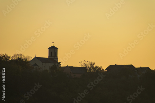Orthodox church in the distance, in the sunlight at sunset. About religion, faith and hope - concept.