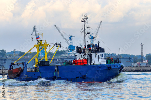 The fishing vessel returns to the harbor in the evening
