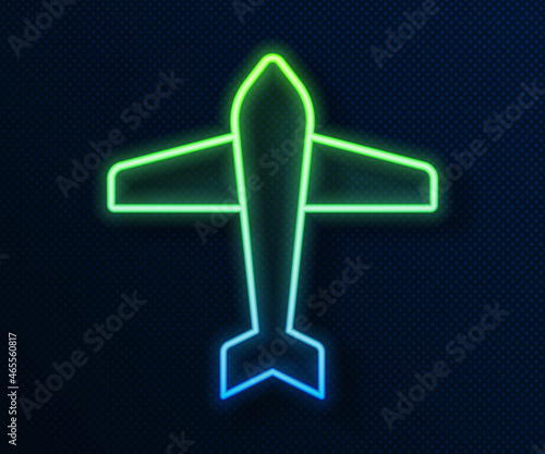 Glowing neon line Jet fighter icon isolated on blue background. Military aircraft. Vector