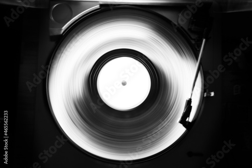 Abstract black and white image of a turntable for vinyl records. Long shutter speed. Motion tracks.