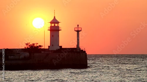 Wallpaper Mural the sea and the morning sun, sunrise over the lighthouse, the calm sea is illuminated by red sunlight in the morning Torontodigital.ca