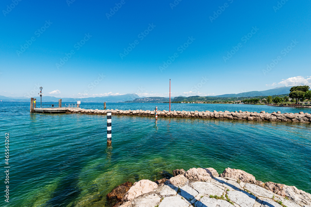 Ferry boats station and entrance of the small port of Cisano, tourist resort on the coast of Lake Garda (Lago di Garda), Bardolino municipality, Verona province, Veneto, Italy, southern Europe.