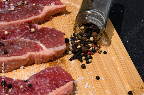 raw meat on a wooden board with seasonings coarse salt and pepper onion igredientes for preparing the churrasco, Brazilian barbecue photo