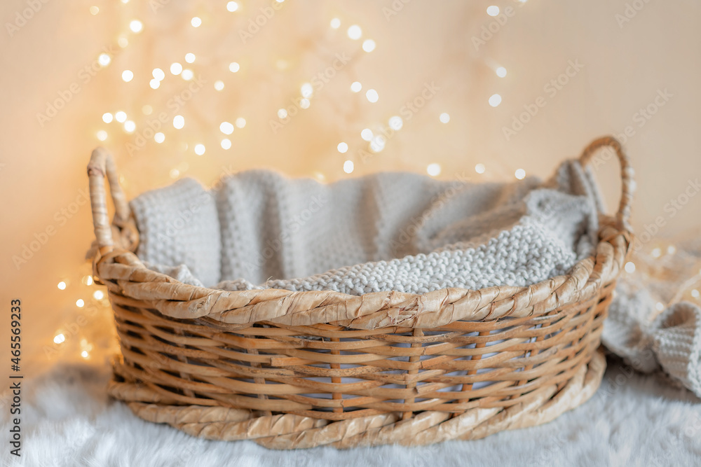 Obraz premium basket for baby with knitted blanket and bokeh background