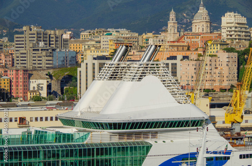 Maintenance refurbishment of luxury passenger ferry cruiseships cruise ship liners in dry dock shipyard in Palermo, Italy with port, industrial and container harbor scenery, marina and boats around photo