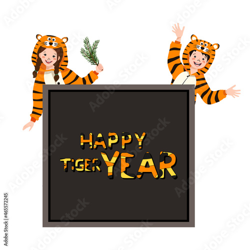 Girl and boy in carnival costume of tiger with place for text. Child in party pyjamas. Kid in jumpsuit or kigurumi, festive clothes for New Year, Christmas or holiday