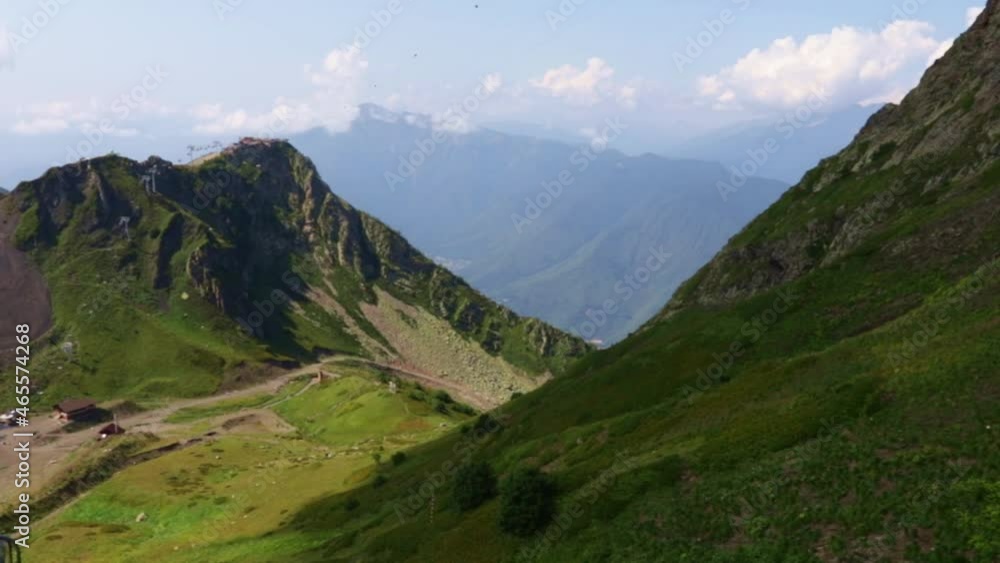 mountain climbing,meadow landscape in summer on the top of the alps,panoramic view of the peaks and green grass