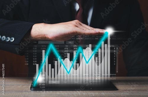 Businessman using tablet analyzing sales data and economic growth graph chart. Business strategy. Digital marketing trade.