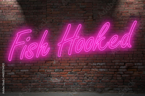 Neon Fish Hook lettering on Brick Wall at night