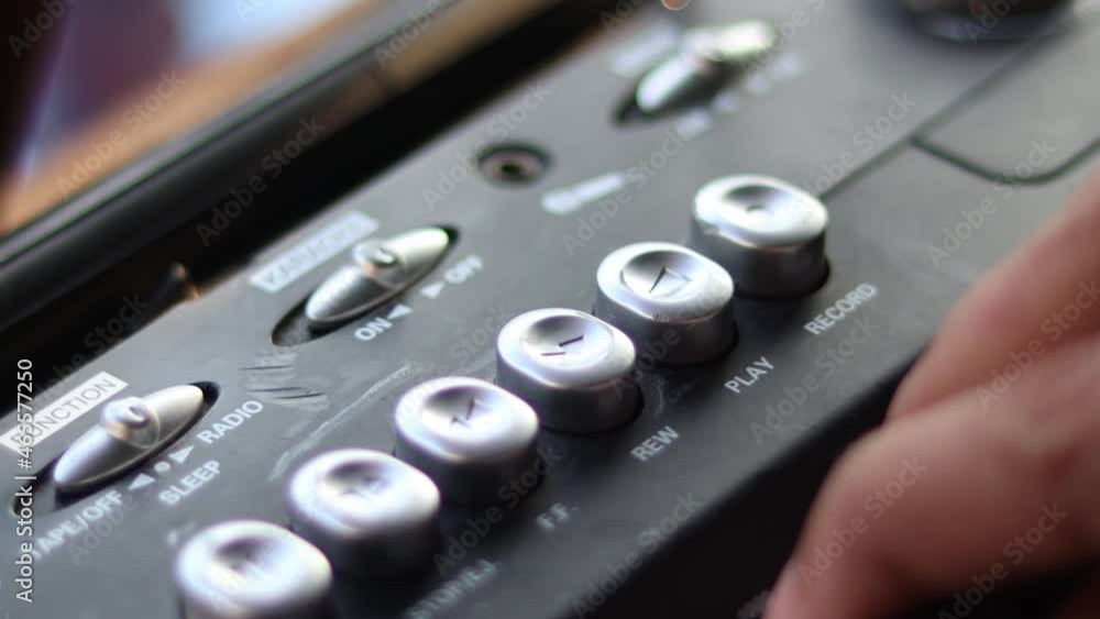 Close Up hand with mustache and mullet from the 70s 80s 90 listens to his music using a portable walkman cassette player. Vintage concept. Close Up hand with mustache and mullet from the 70s 80s 90 listens to his music using a portable walkman cassette player. Vintage concept.