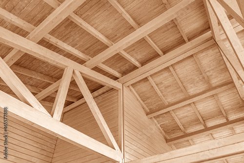 фотографія Wooden roof construction. Part of the floor of a wooden house.