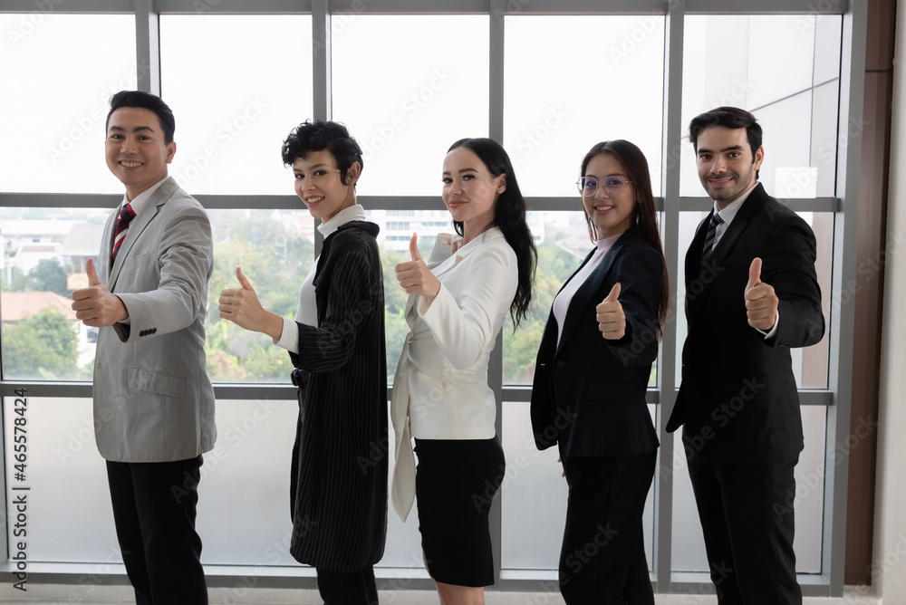 Young businessman raise your hand. Like, happy because the job was successful. Everyone smiles with joy. Good planning of work leads to the achievement of goals. Business success. Young businessman raise your hand. Like, happy because the job was successful. Everyone smiles with joy. Good planning of work leads to the achievement of goals. Business success.