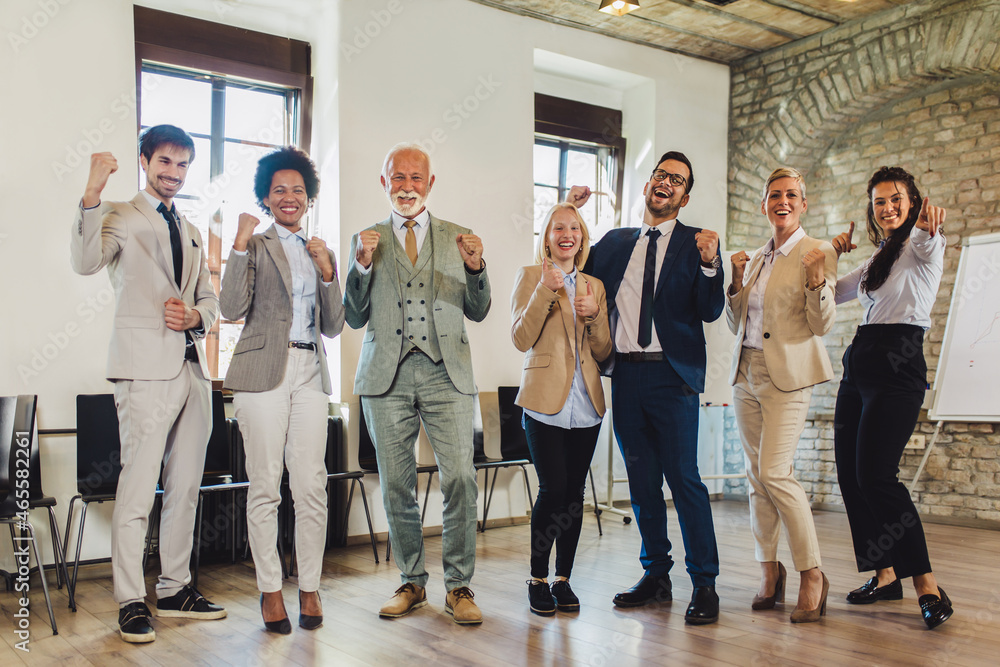 Fototapeta premium Happy business people celebrating success at company.