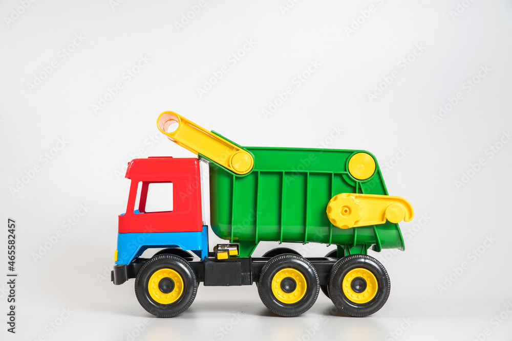 Multi-colored plastic children's toy cars on a white background. Truck.