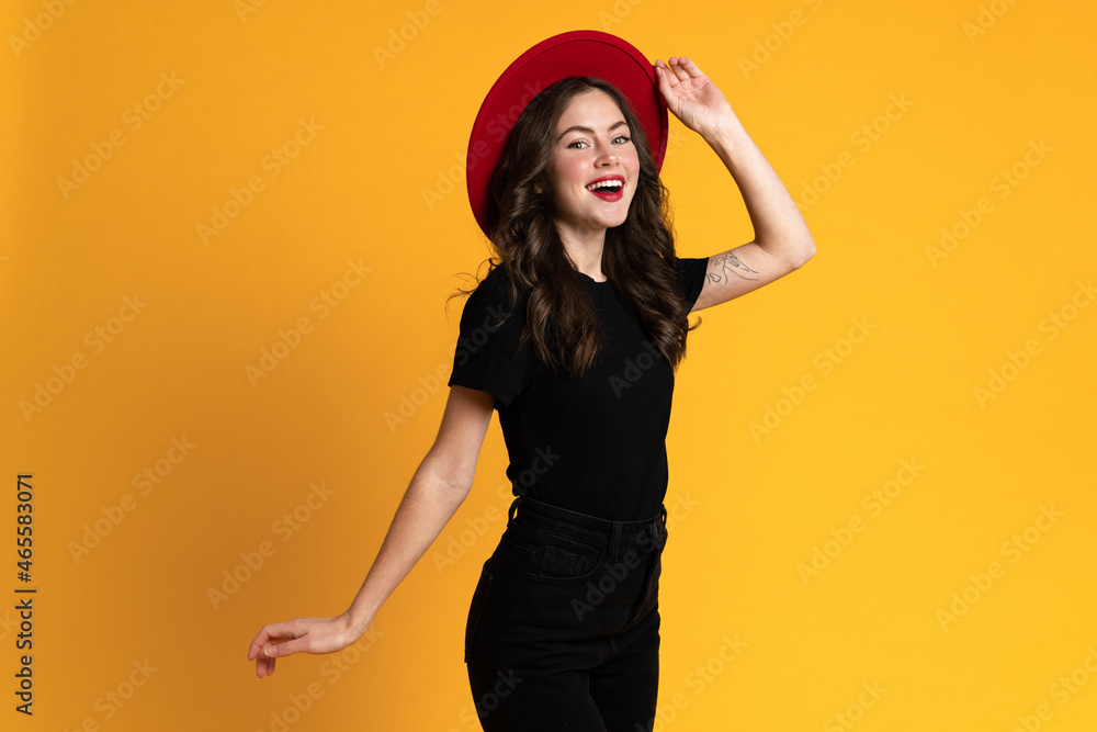White young woman in red hat smiling while looking at camera White young woman in red hat smiling while looking at camera