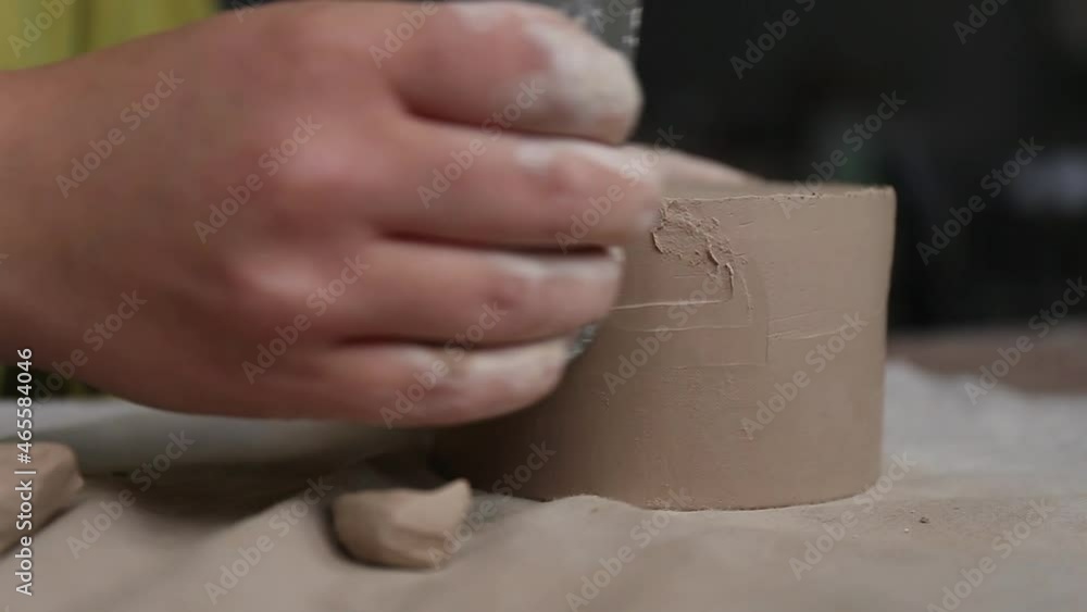 Female ceramist working in pottery studio. Ceramist's Hands Dirty Of Clay. Process of creating pottery. Master ceramist works in her studio Female ceramist working in pottery studio. Ceramist's Hands Dirty Of Clay. Process of creating pottery. Master ceramist works in her studio