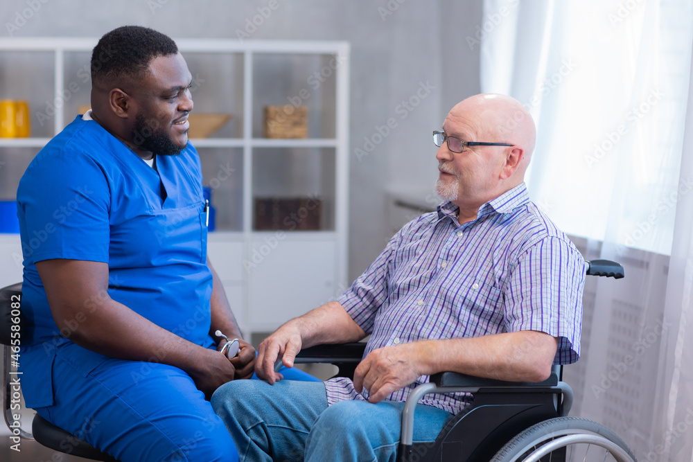 Caregiver and old man in a wheelchair. Professional nurse and patient in a nursing home. Assistance, rehabilitation and health care. Caregiver and old man in a wheelchair. Professional nurse and patient in a nursing home. Assistance, rehabilitation and health care.