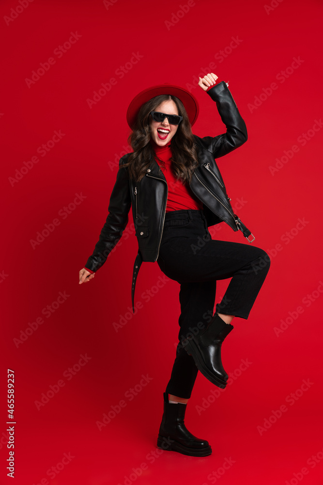 White woman in leather jacket laughing while dancing on camera White woman in leather jacket laughing while dancing on camera