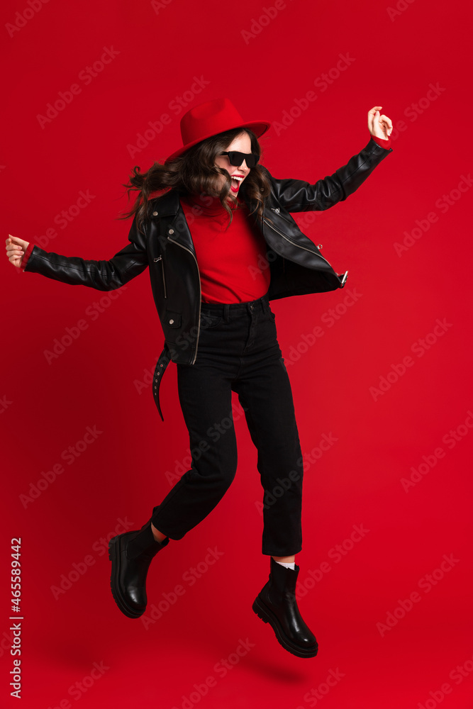 White woman in leather jacket laughing while dancing on camera White woman in leather jacket laughing while dancing on camera