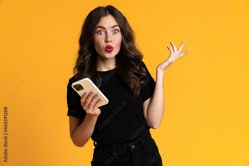 White young woman expressing surprise while using mobile phone White young woman expressing surprise while using mobile phone