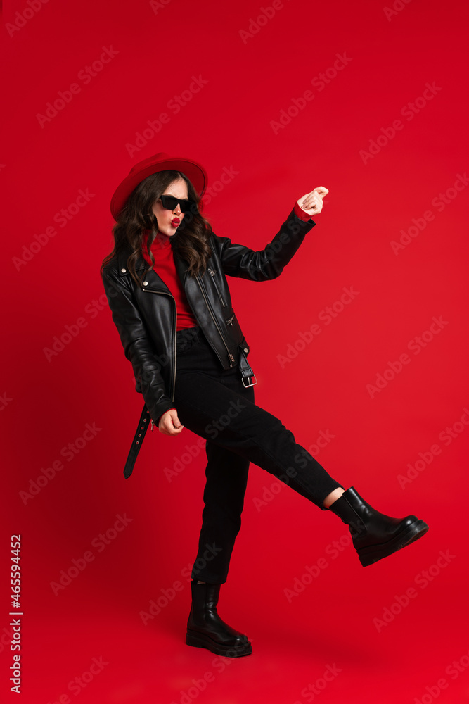 White woman in leather jacket laughing while dancing on camera White woman in leather jacket laughing while dancing on camera