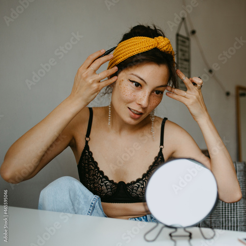 attractive woman doing makeup at home 