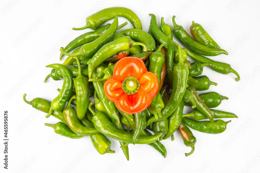 green hot peppers and red bell peppers on a white background. vitamin vegetables for health green hot peppers and red bell peppers on a white background. vitamin vegetables for health