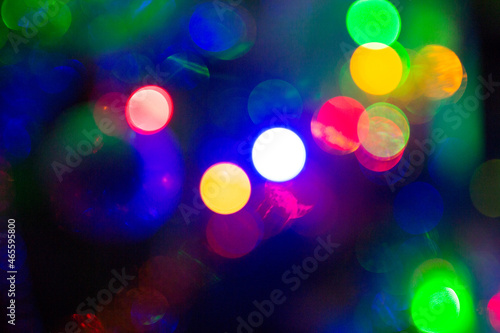blurred background is Christmas lights. glare from lens is a beautiful New Year's bokeh. concept is a festive atmosphere.