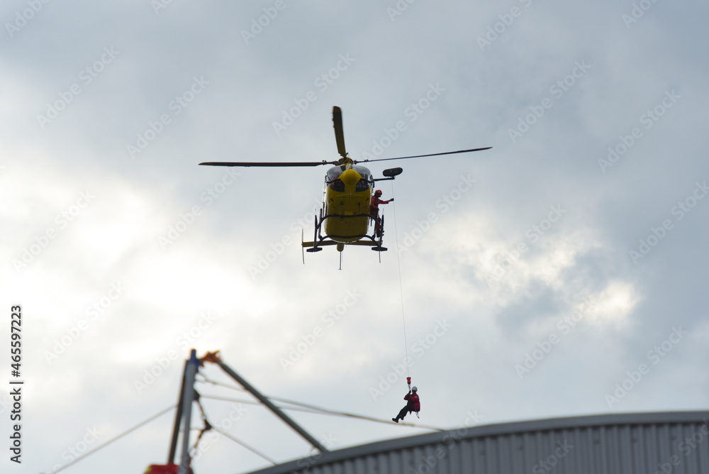 firefighters evacuating a casualty by helicopter during a training firefighters evacuating a casualty by helicopter during a training