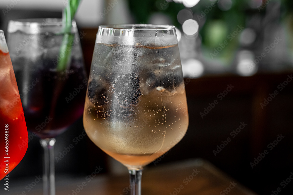 Fototapeta premium Aperitif is a refreshing cocktail of lemonade made from citrus slices. Soft drink with syrup and soda and ice cubes. Concept - summer thirst