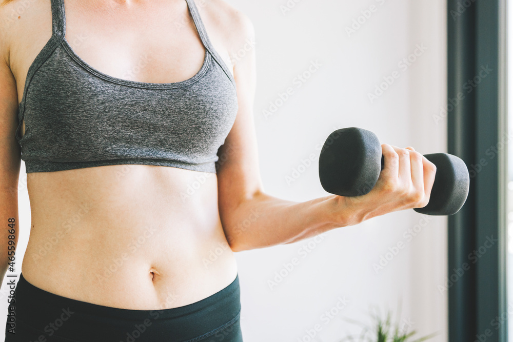 beautiful girl with dumbbells. Fitness classes at home. Strength training