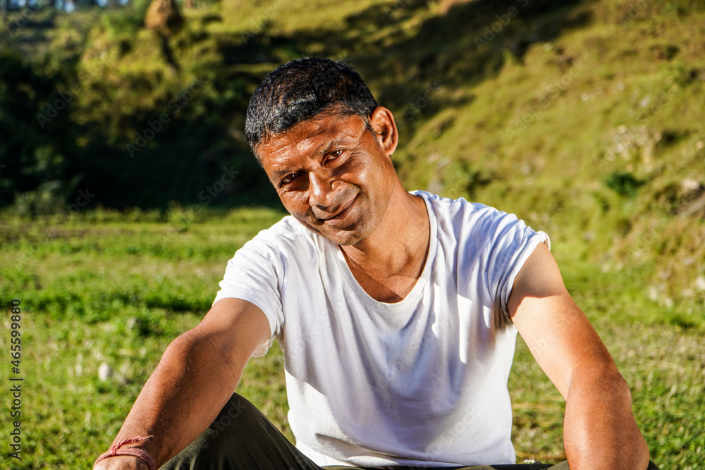Portrait of a young indian farmer resting in the fields captured early in the morning. Portrait of a young indian farmer resting in the fields captured early in the morning.