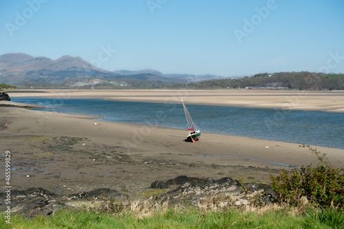 Landscape view over Borth-y-Gest towards Snowdonia mountains, Wales,  with the estuary at low tide on a spring day .