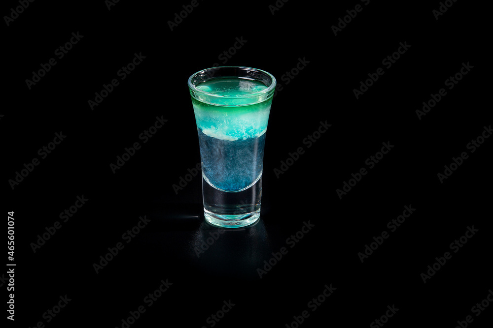 aperitif is an alcoholic cocktail made from various ingredients. Cocktail - one glass on a black background. concept is a holiday party. aperitif is an alcoholic cocktail made from various ingredients. Cocktail - one glass on a black background. concept is a holiday party.