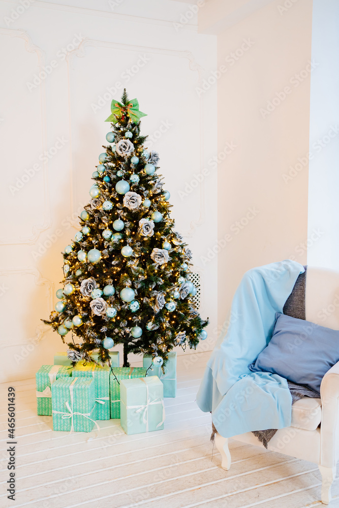 chair with blue pillow and blanket against near christmas tree with garland