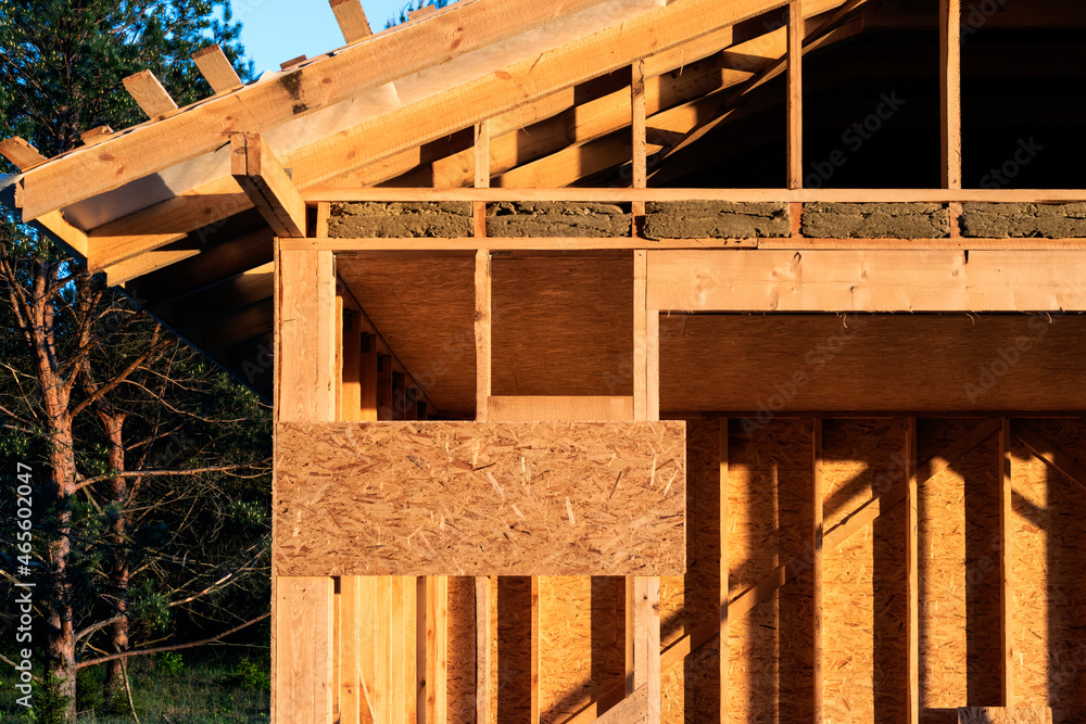 Wooden rural building under construction in nature at bright sunny day. Wooden rural building under construction in nature at bright sunny day.