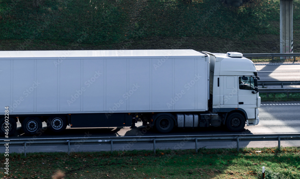 Side view of white truck on the highway. Stock Photo | Adobe Stock