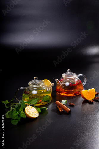 A teapot with black and green tea from various varieties of leaves. Tea drink with pieces of citrus fruits. concept is a tea ceremony.