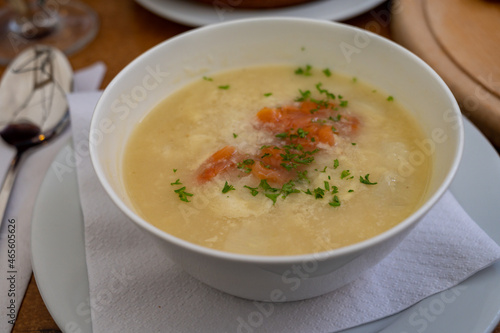 Seasonal dish, white asparagus cream soup with smoked salmon fish